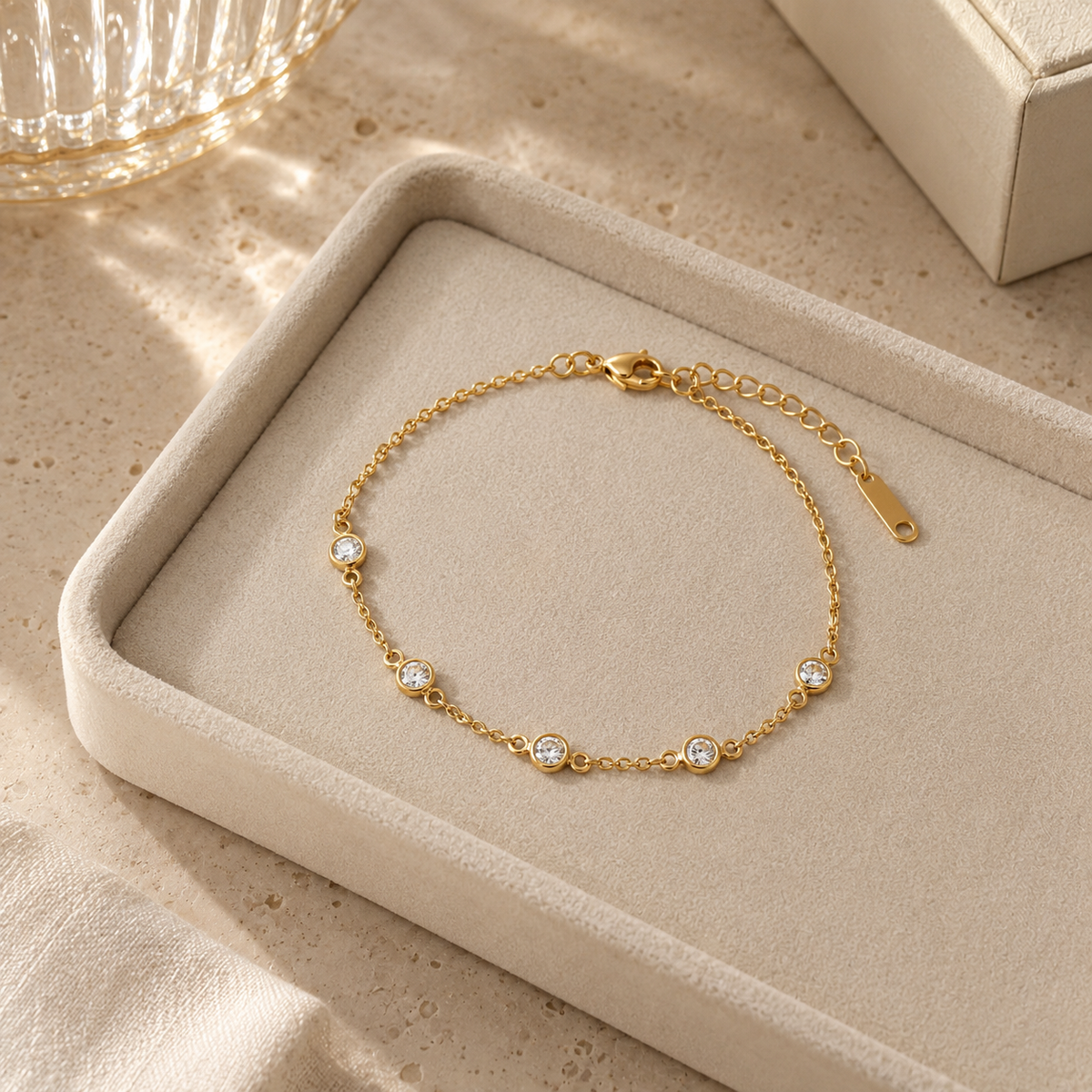Gold zircon bracelet displayed on a jewelry tray