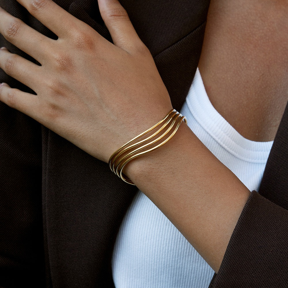 Woman wearing a gold stainless steel open cuff bracelet