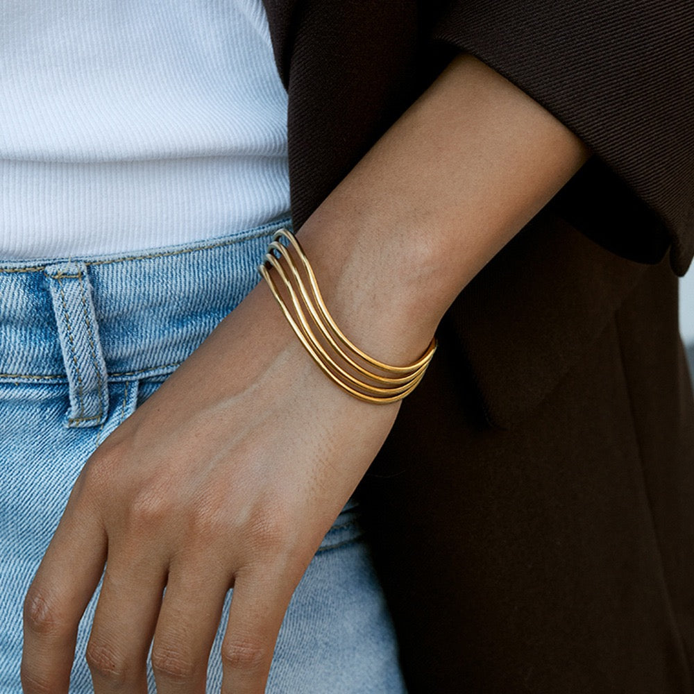 Woman wearing a gold stainless steel open cuff bracelet