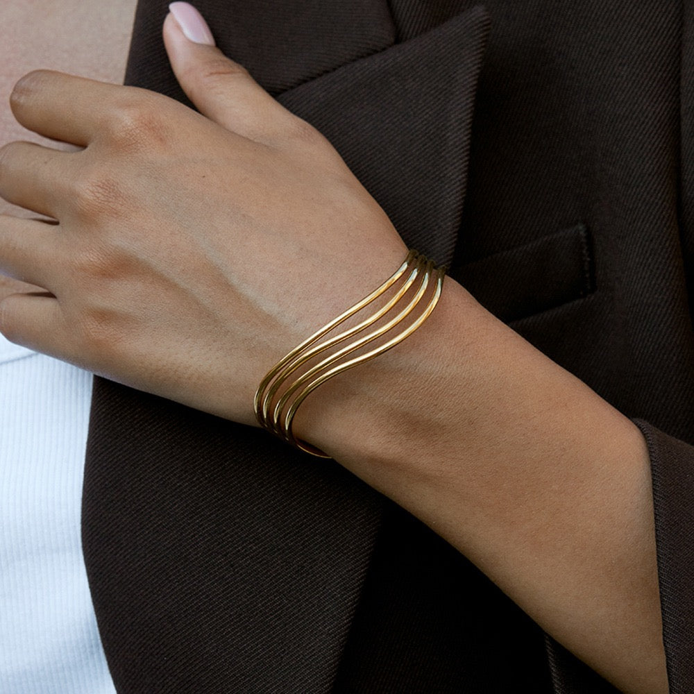 Woman wearing a gold stainless steel open cuff bracelet