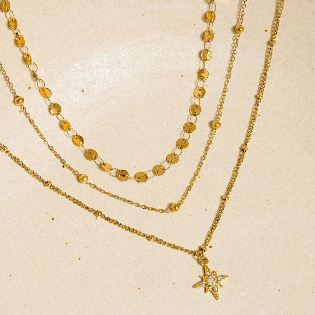 Close-up of gold Celeste Layered Eight-Point Star Necklace
